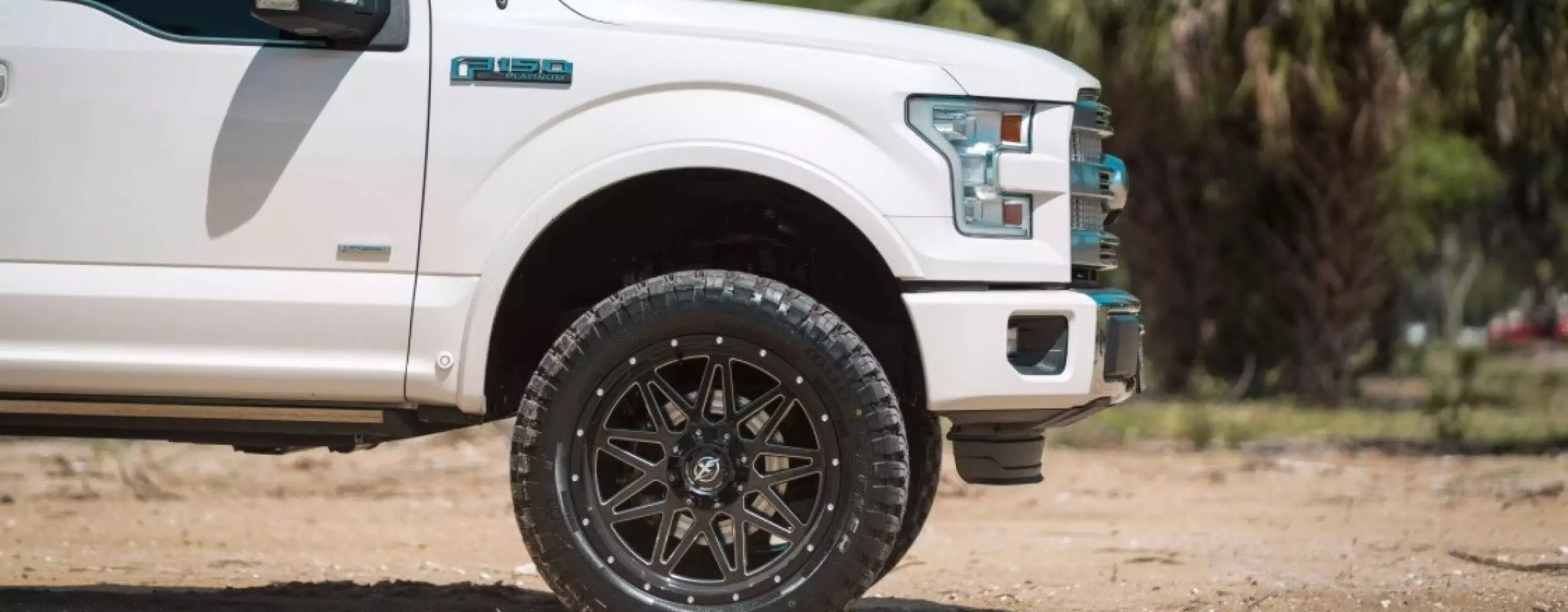 image of truck on dirt road with new wheels and rims on the rotating banner on the home page